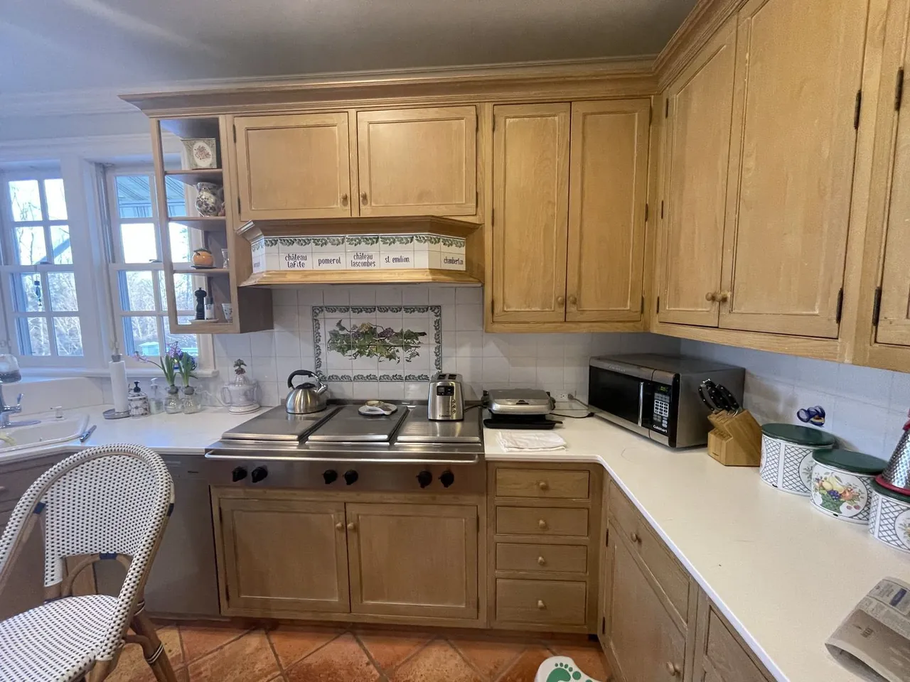 The kitchen before renovation: pickled oak cabinets and a terracotta tile floor